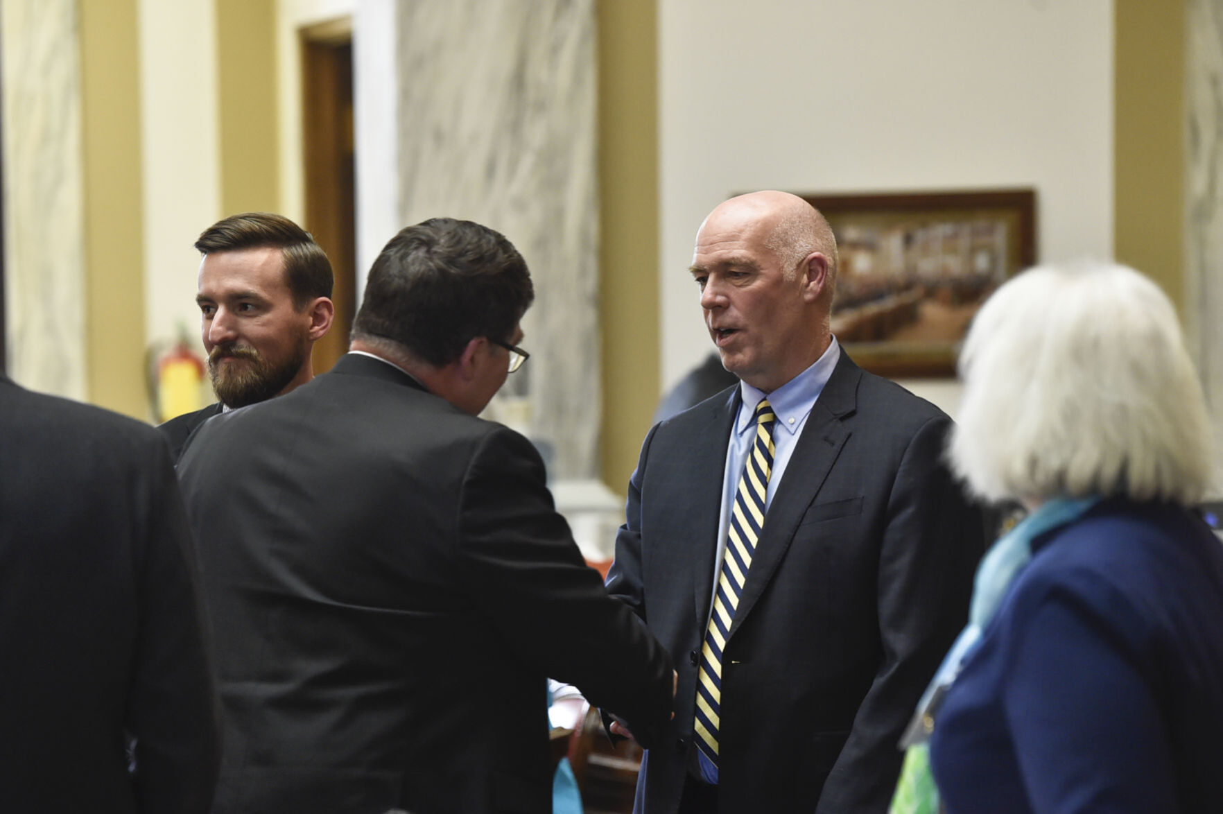 Gov. Greg Gianforte talks with legislators on the House floor on Thursday, April 29, 2021.